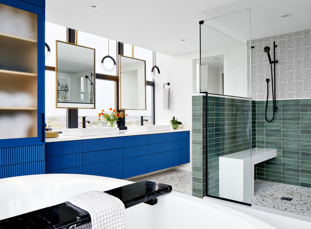 На фото: главная ванная комната в современном стиле с синими фасадами, белыми стенами, полом из терраццо, разноцветным полом, белой столешницей, сиденьем для душа, тумбой под две раковины, подвесной тумбой, черно-белой плиткой, зеленой плиткой, разноцветной плиткой и настольной раковиной