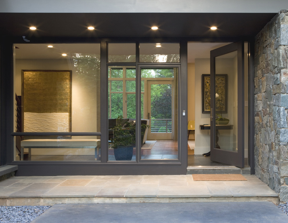 Photo of a mid-sized contemporary front door in DC Metro with a single front door and a glass front door.