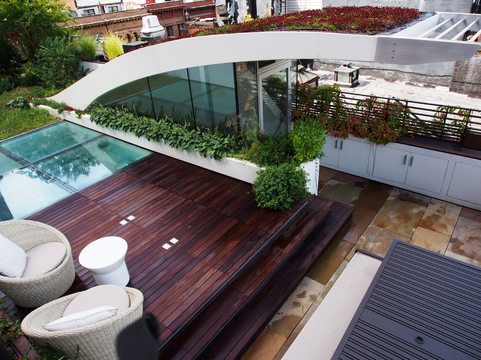 Inspiration for a mid-sized contemporary rooftop deck in New York with an awning.