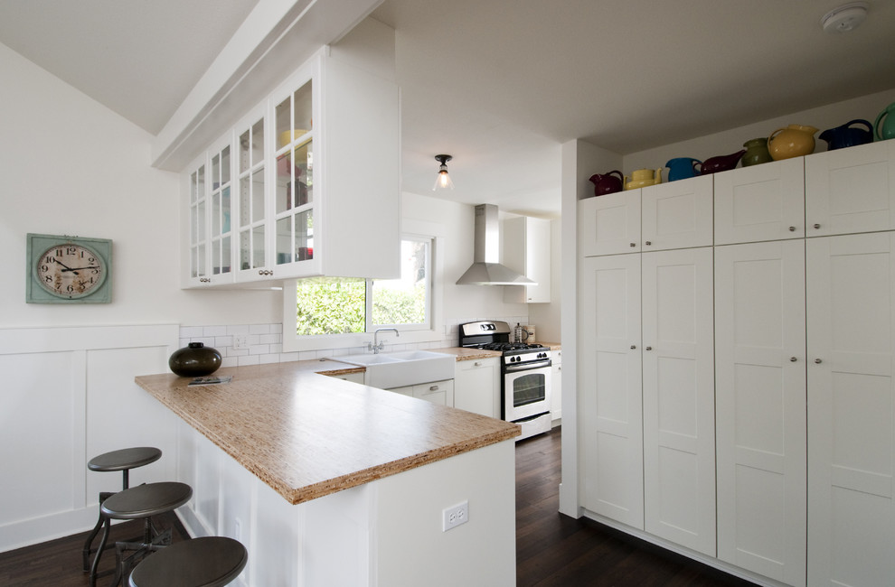 Photo of a contemporary kitchen in San Diego with glass-front cabinets and a double-bowl sink.