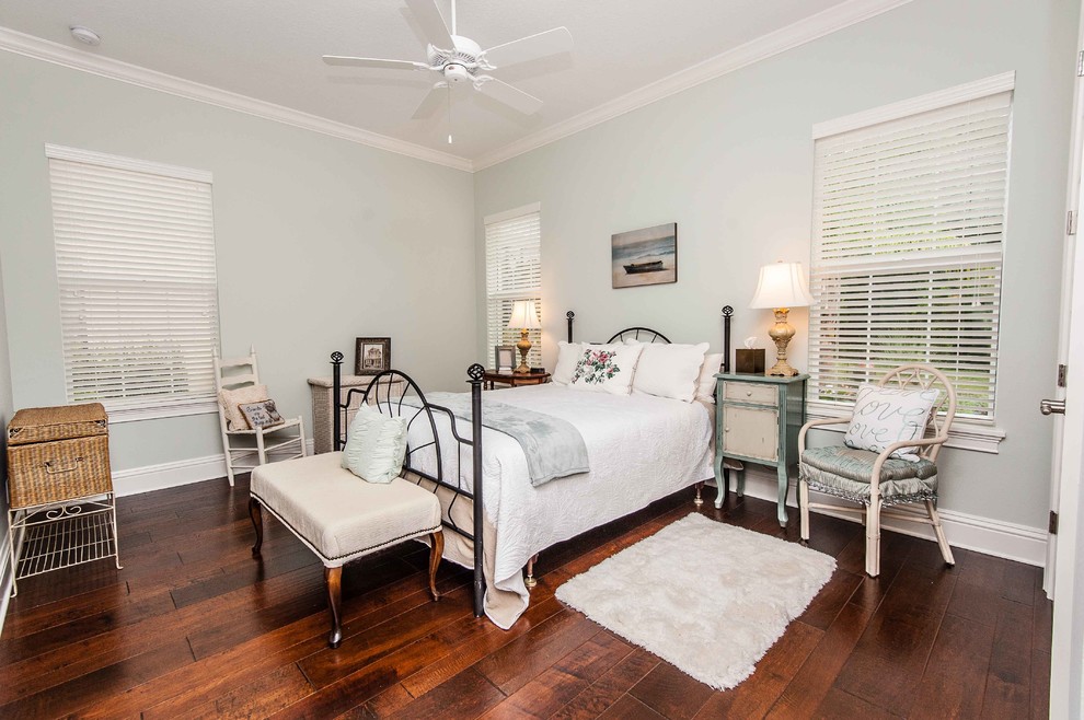 Photo of a traditional guest bedroom in Orlando with grey walls and dark hardwood floors.