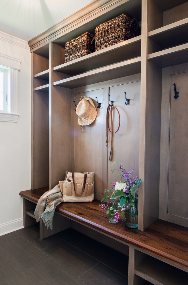 Inspiration for a mid-sized traditional entryway in New York with white walls, laminate floors and black floor.