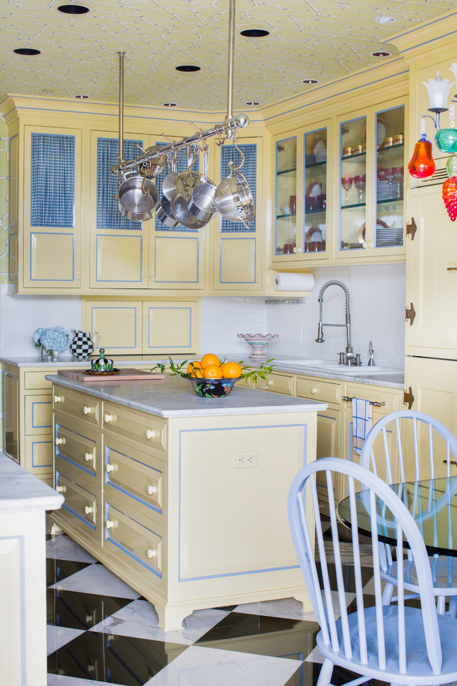 Inspiration for a traditional l-shaped eat-in kitchen in Other with raised-panel cabinets, yellow cabinets, white splashback and with island.