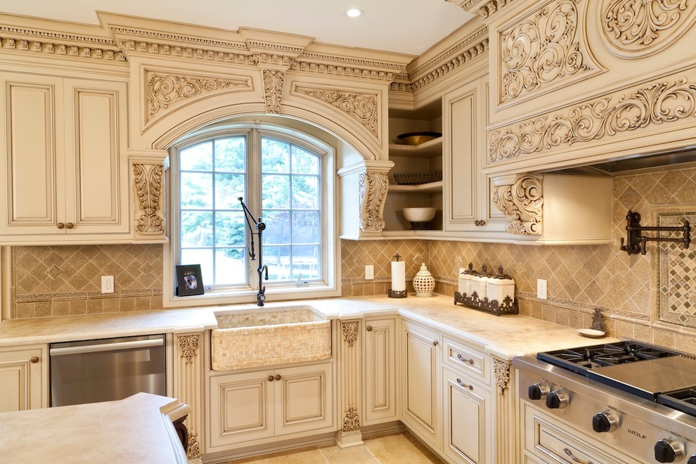 Design ideas for a mid-sized traditional u-shaped separate kitchen in New York with a farmhouse sink, raised-panel cabinets, beige cabinets, marble benchtops, beige splashback, ceramic splashback, stainless steel appliances, ceramic floors, with island, beige floor and beige benchtop.