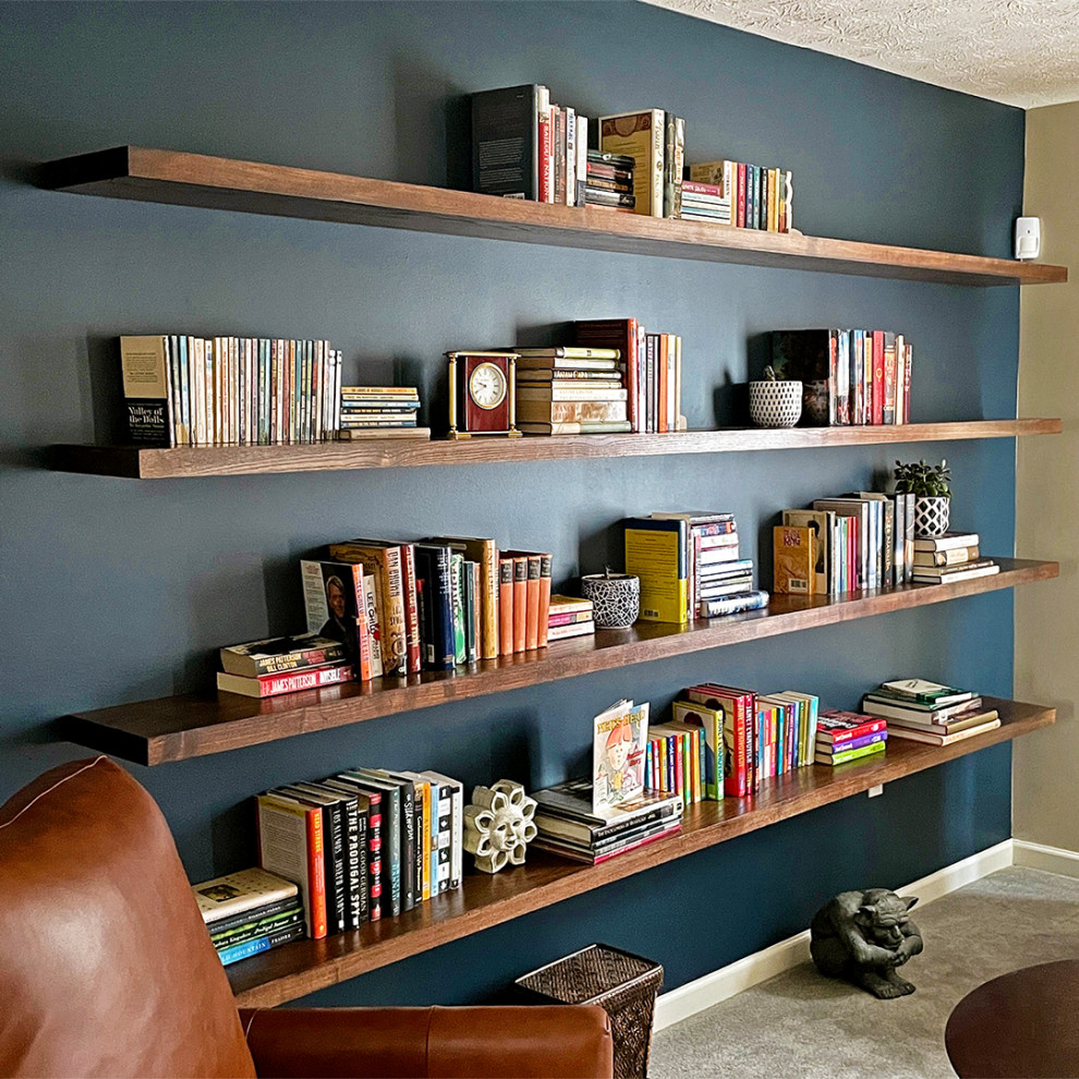 Imagen de biblioteca en casa cerrada minimalista de tamaño medio sin televisor con paredes azules, moqueta y suelo beige