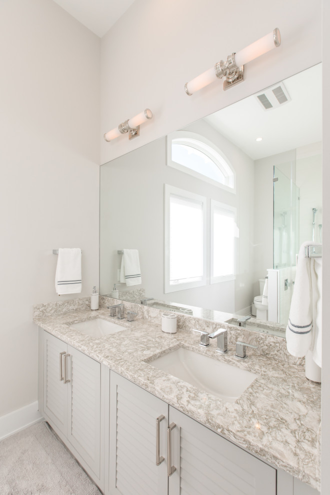 Photo of a large transitional master bathroom in Other with louvered cabinets, grey cabinets, grey walls, an undermount sink, grey floor, grey benchtops, a double vanity and a built-in vanity.