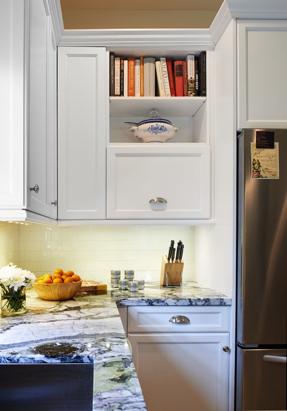 Example of a small transitional u-shaped medium tone wood floor eat-in kitchen design in Denver with a single-bowl sink, recessed-panel cabinets, white cabinets, marble countertops, white backsplash, ceramic backsplash, stainless steel appliances and a peninsula