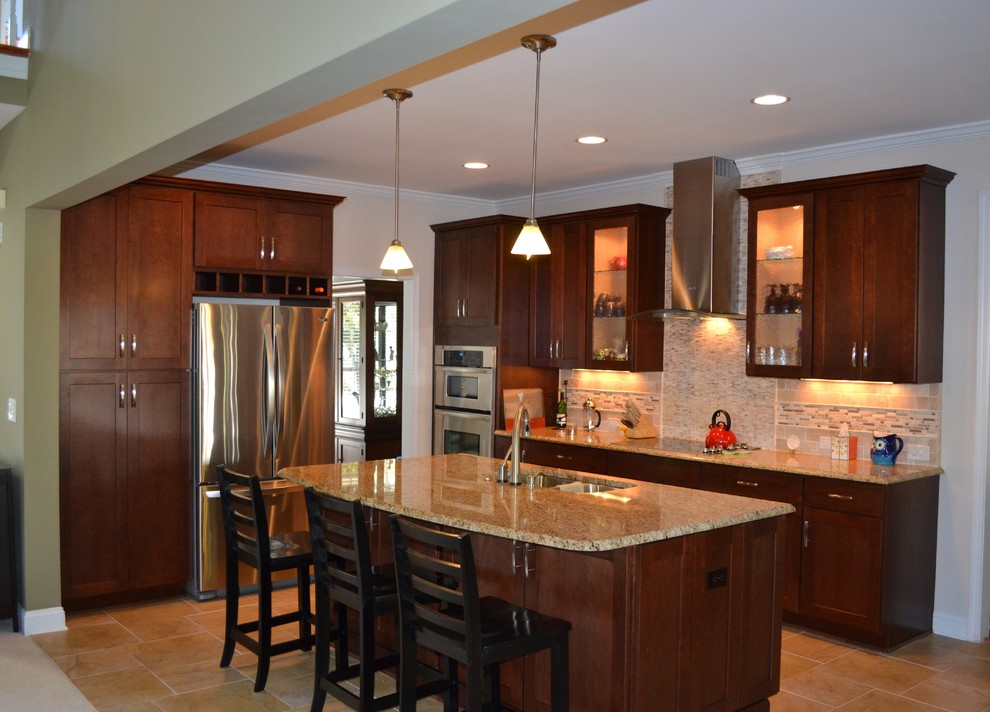Open concept kitchen - transitional open concept kitchen idea in Charlotte with an undermount sink, dark wood cabinets, beige backsplash, stainless steel appliances and an island