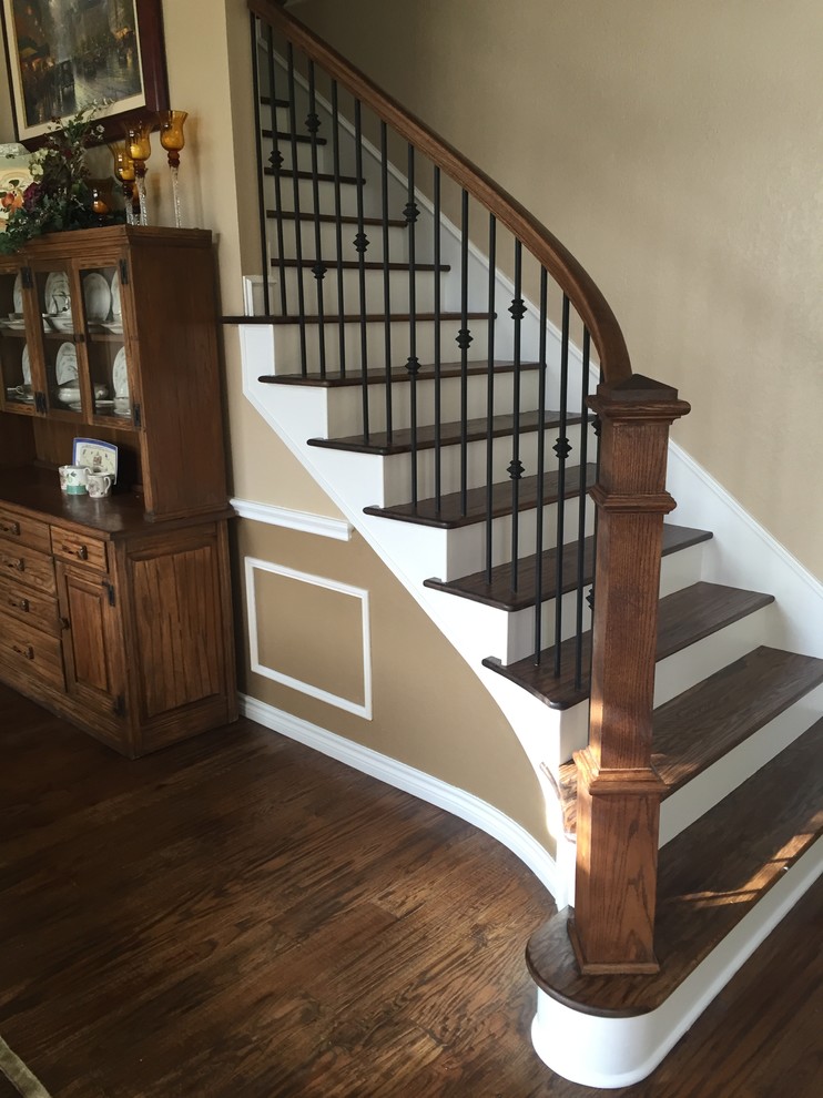 This is an example of a mid-sized traditional wood straight staircase in Dallas with painted wood risers and metal railing.
