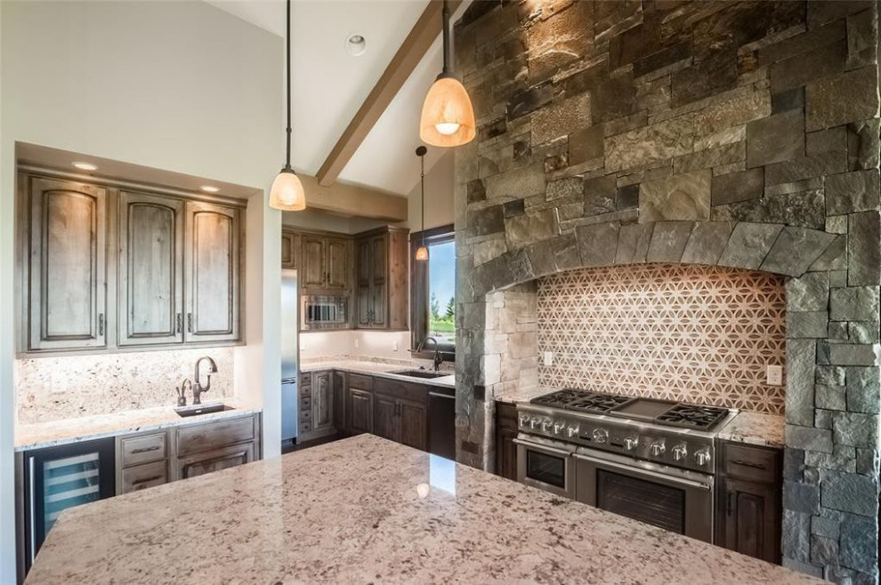 Example of a large transitional galley dark wood floor, brown floor and vaulted ceiling open concept kitchen design with a drop-in sink, raised-panel cabinets, medium tone wood cabinets, granite countertops, multicolored backsplash, stainless steel appliances, an island and white countertops