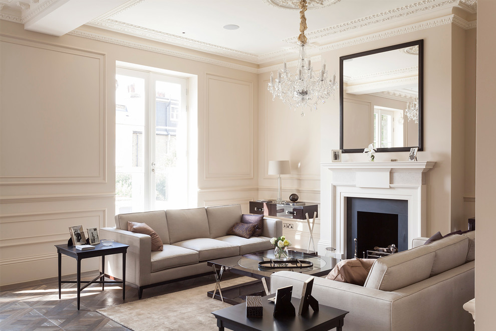 Transitional formal living room in London with beige walls, dark hardwood floors and a standard fireplace.