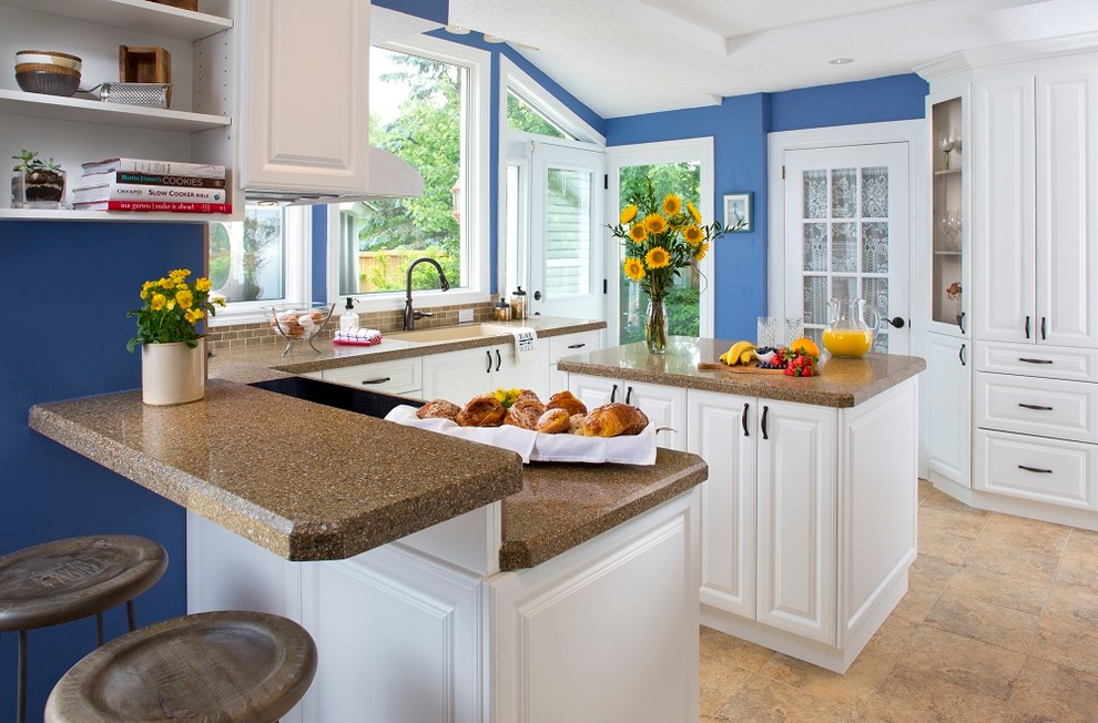 Inspiration for a mid-sized country l-shaped ceramic tile, brown floor and tray ceiling kitchen pantry remodel in Jacksonville with an undermount sink, raised-panel cabinets, white cabinets, granite countertops, brown backsplash, porcelain backsplash, paneled appliances, an island and multicolored countertops