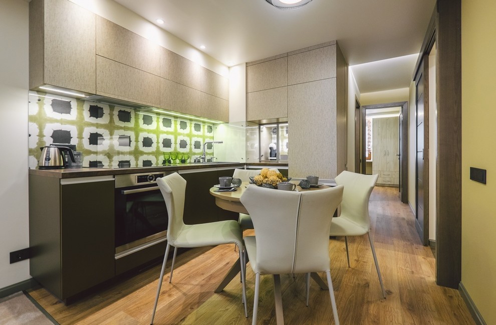 Example of a small minimalist formal and enclosed light wood floor home design design with multicolored walls, no fireplace and a tv stand