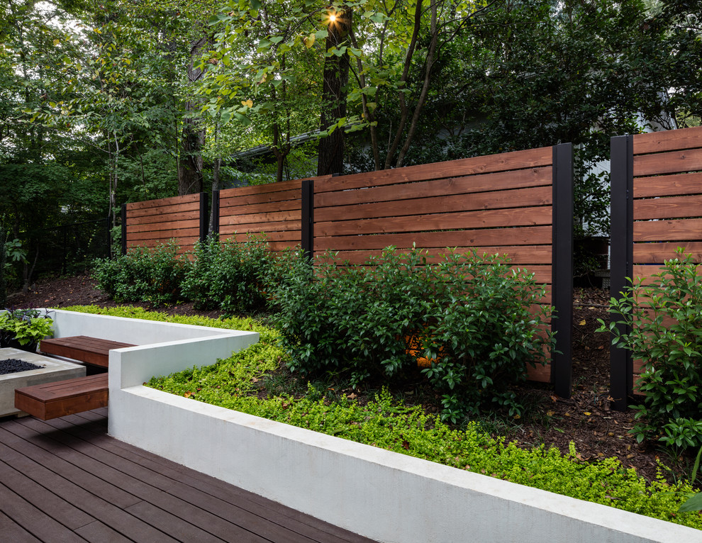 Photo of a large contemporary backyard deck in Atlanta with a fire feature, a pergola and metal railing.