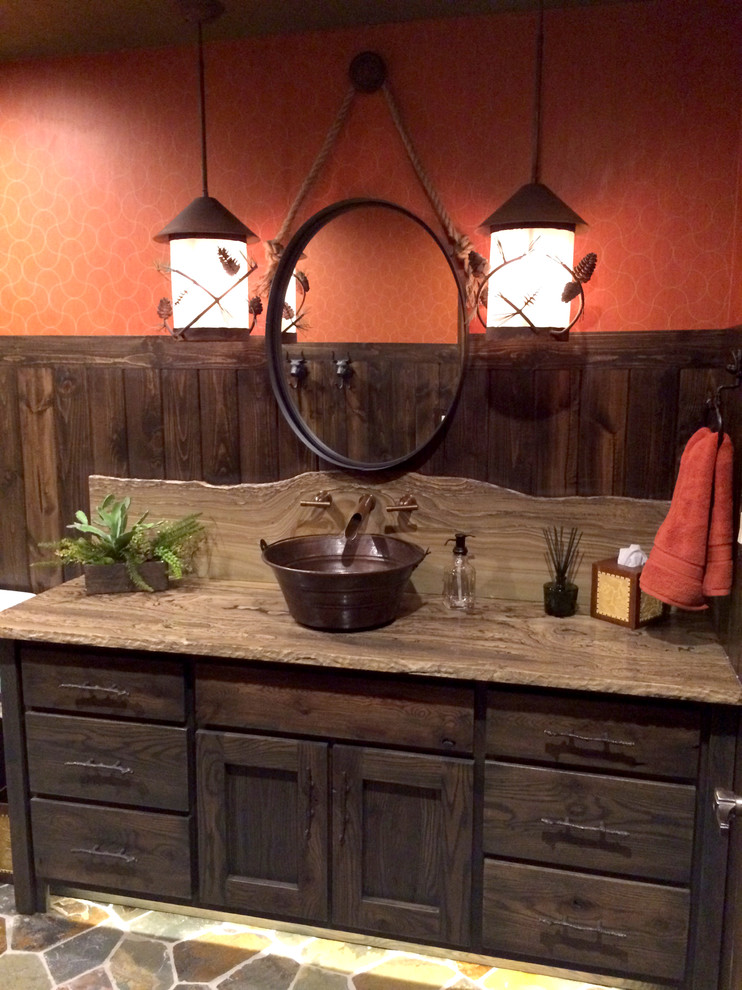 Drop-in bathtub - mid-sized rustic drop-in bathtub idea with furniture-like cabinets, green cabinets, a two-piece toilet, orange walls, a vessel sink and quartzite countertops