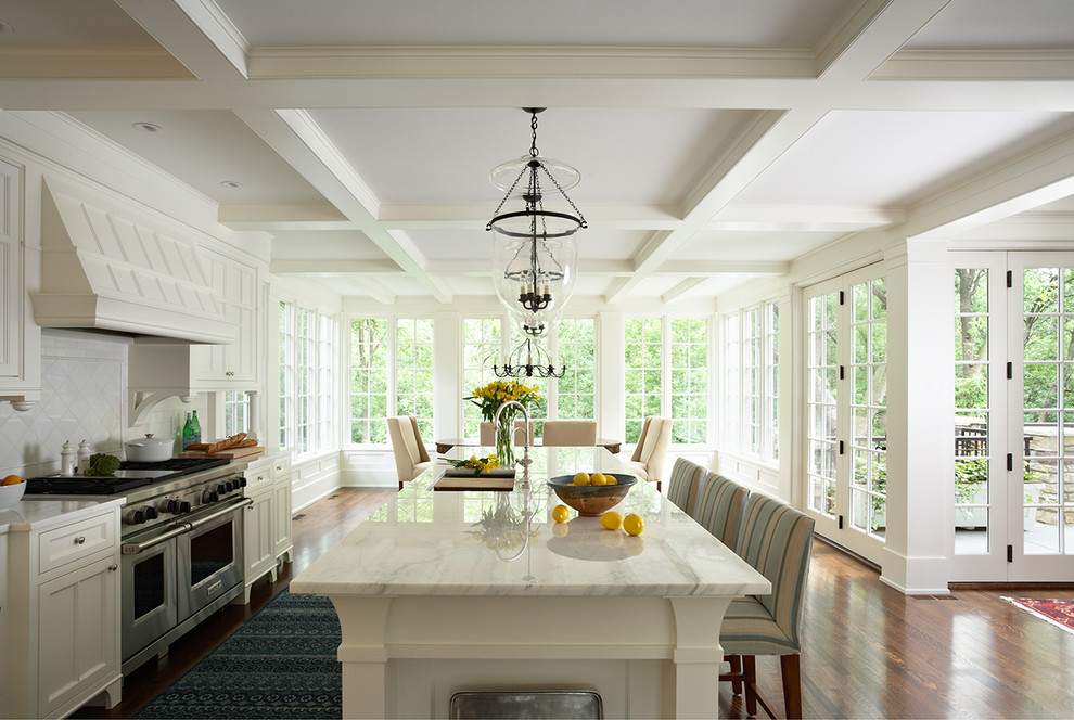 Huge elegant l-shaped dark wood floor open concept kitchen photo in Minneapolis with recessed-panel cabinets, white cabinets, marble countertops, stainless steel appliances, an undermount sink, white backsplash, subway tile backsplash and an island