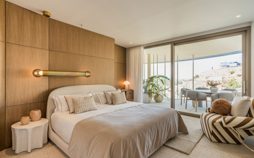 Example of a trendy concrete floor, gray floor and wood wall bedroom design with brown walls