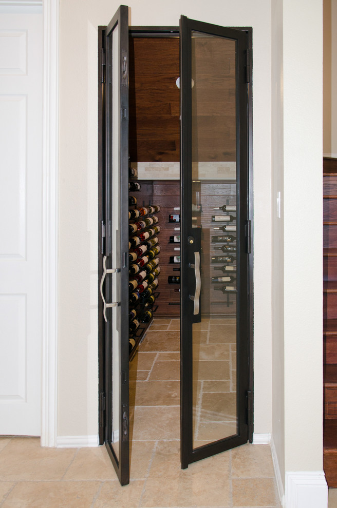 Inspiration for a mediterranean wine cellar in Dallas with travertine floors and display racks.