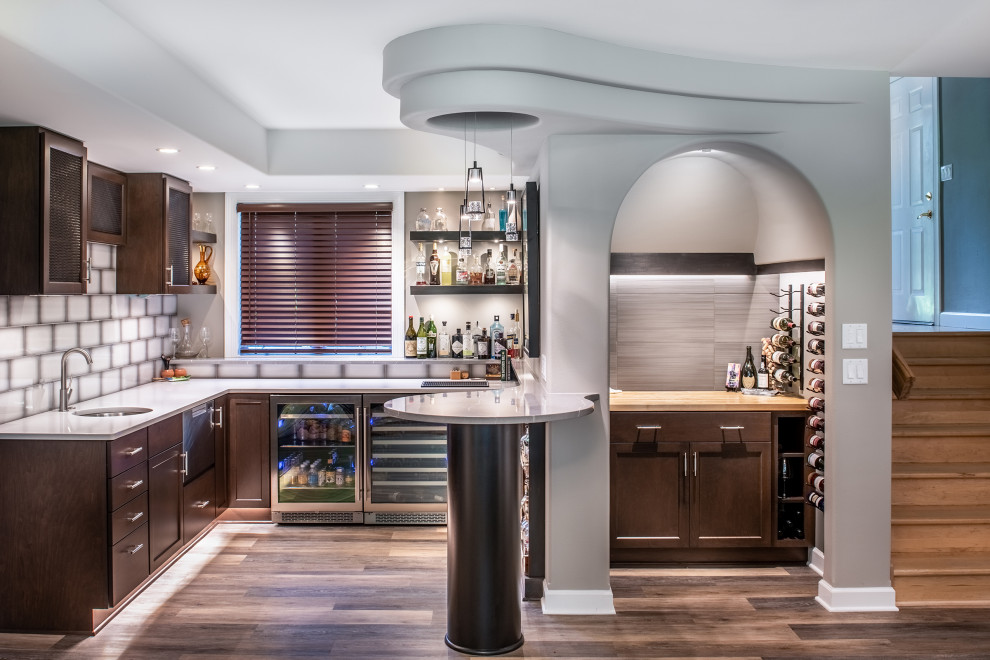 Design ideas for a small contemporary l-shaped wet bar in Other with a submerged sink, shaker cabinets, dark wood cabinets, white splashback and glass tiled splashback.