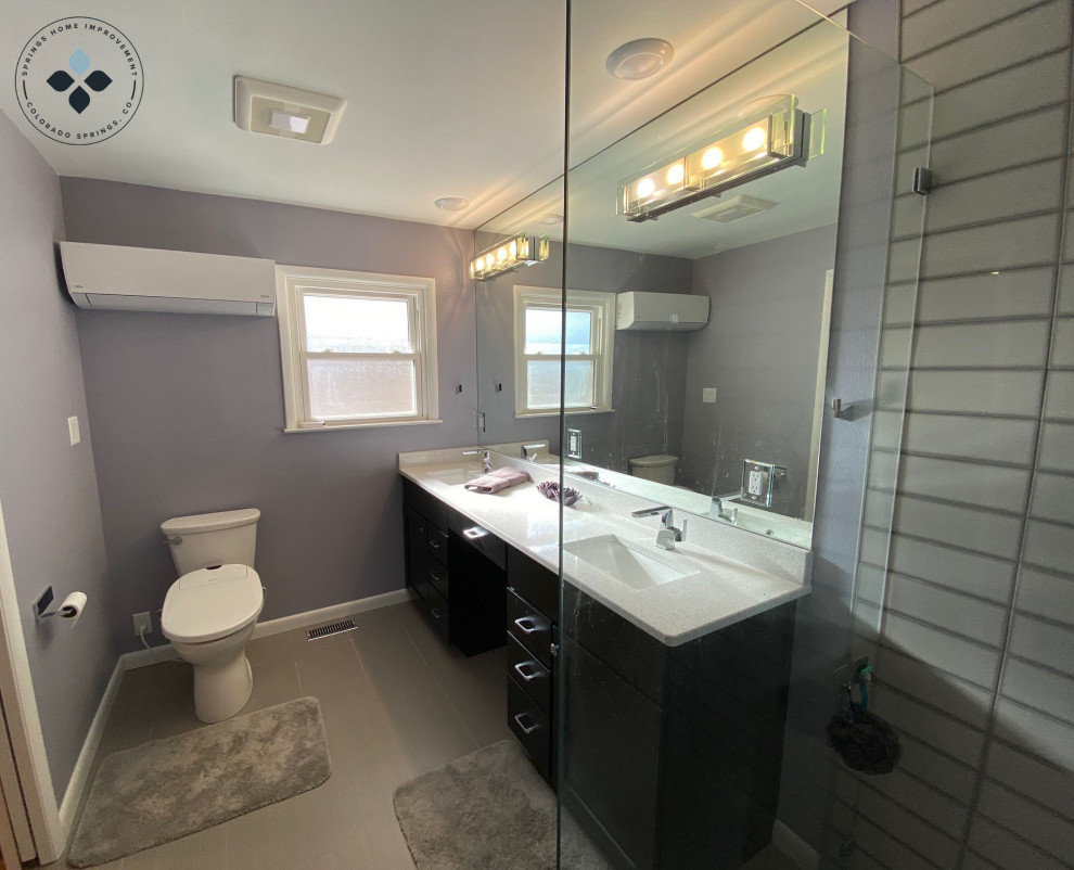 Photo of a large contemporary master bathroom in Denver with black cabinets, a curbless shower, beige tile, purple walls, ceramic floors, a drop-in sink, engineered quartz benchtops, beige floor, an open shower, white benchtops and a double vanity.