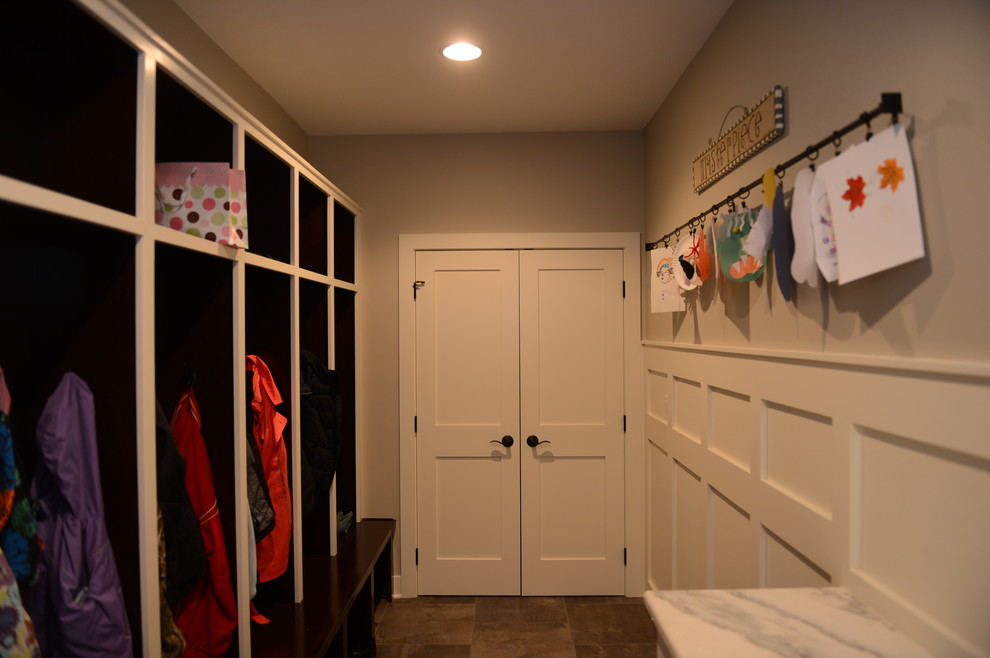 Inspiration for a large transitional brown floor mudroom remodel with gray walls