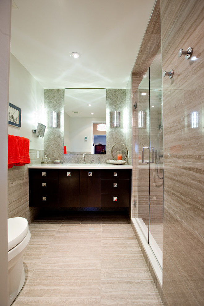 Photo of a small contemporary master bathroom in Other with flat-panel cabinets, dark wood cabinets, an alcove shower, a two-piece toilet, gray tile, travertine, white walls, porcelain floors, an undermount sink, engineered quartz benchtops and beige floor.