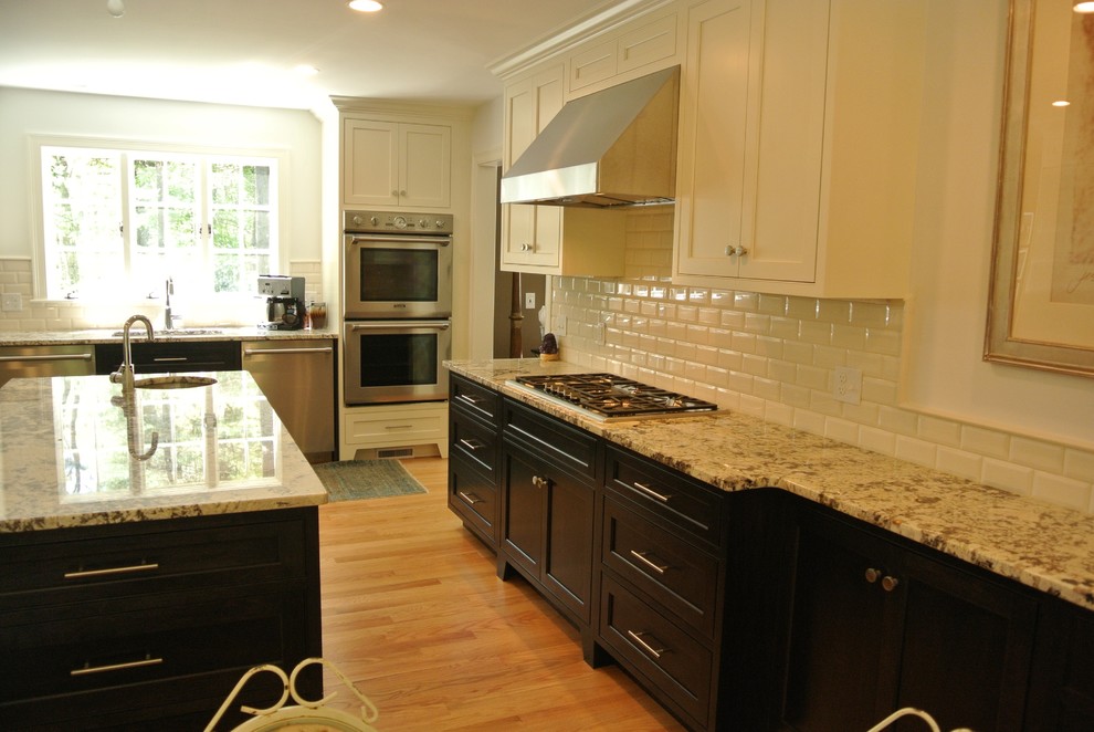 Eat-in kitchen - transitional light wood floor eat-in kitchen idea in Boston with an undermount sink, shaker cabinets, granite countertops, white backsplash, subway tile backsplash, stainless steel appliances and an island