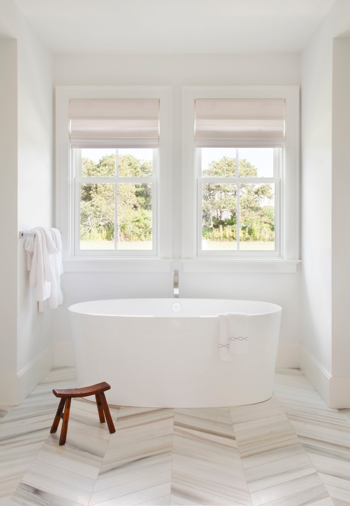Inspiration for a transitional bathroom in Providence with a freestanding tub and white walls.