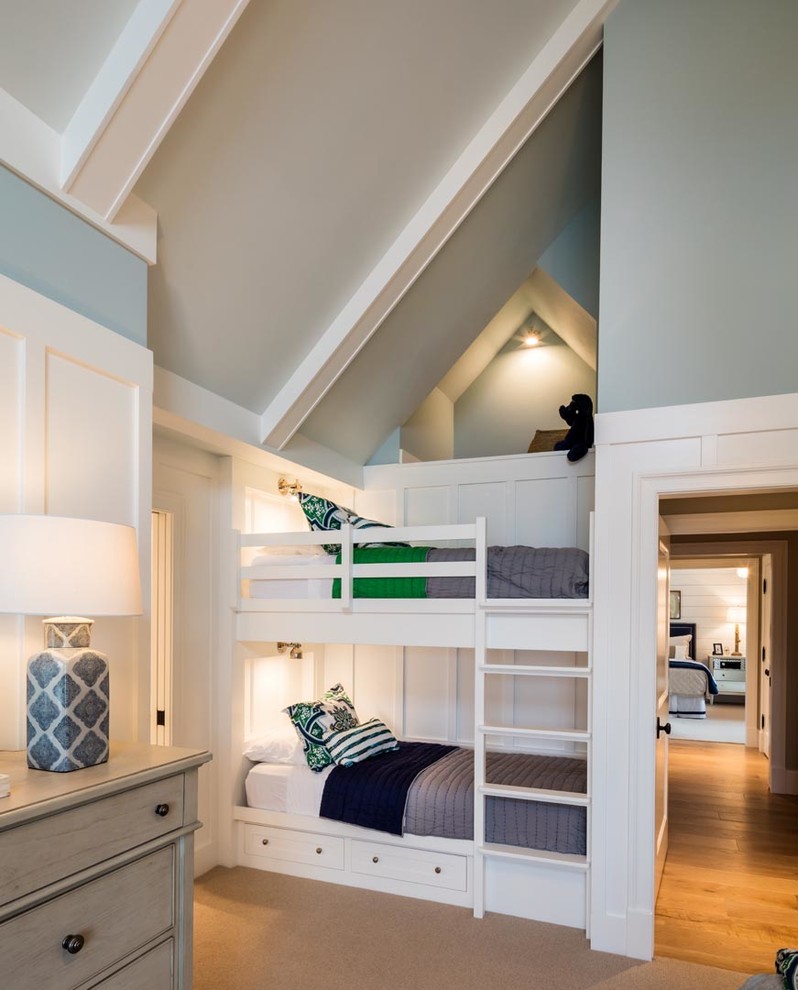 Beach style gender-neutral kids' bedroom in Other with blue walls, carpet and brown floor.