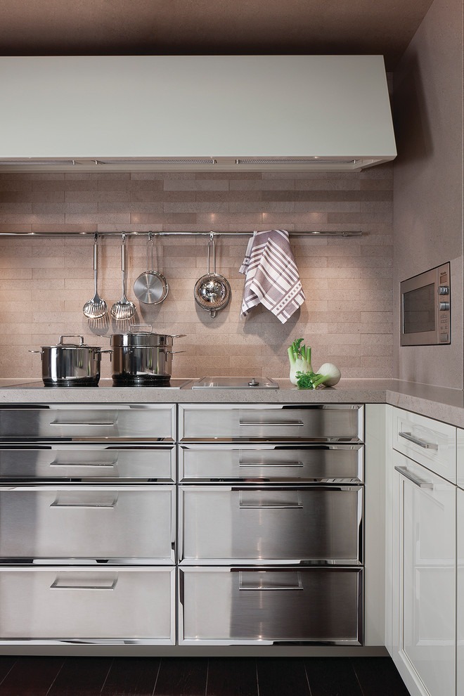 Photo of a contemporary eat-in kitchen in San Diego with recessed-panel cabinets, stainless steel cabinets, limestone benchtops, beige splashback and stone tile splashback.