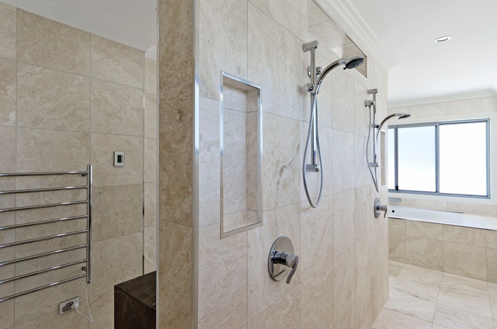 This is an example of a modern master bathroom in Brisbane with a vessel sink, beige cabinets, engineered quartz benchtops, an alcove tub, an open shower, a one-piece toilet, beige tile, ceramic tile and ceramic floors.