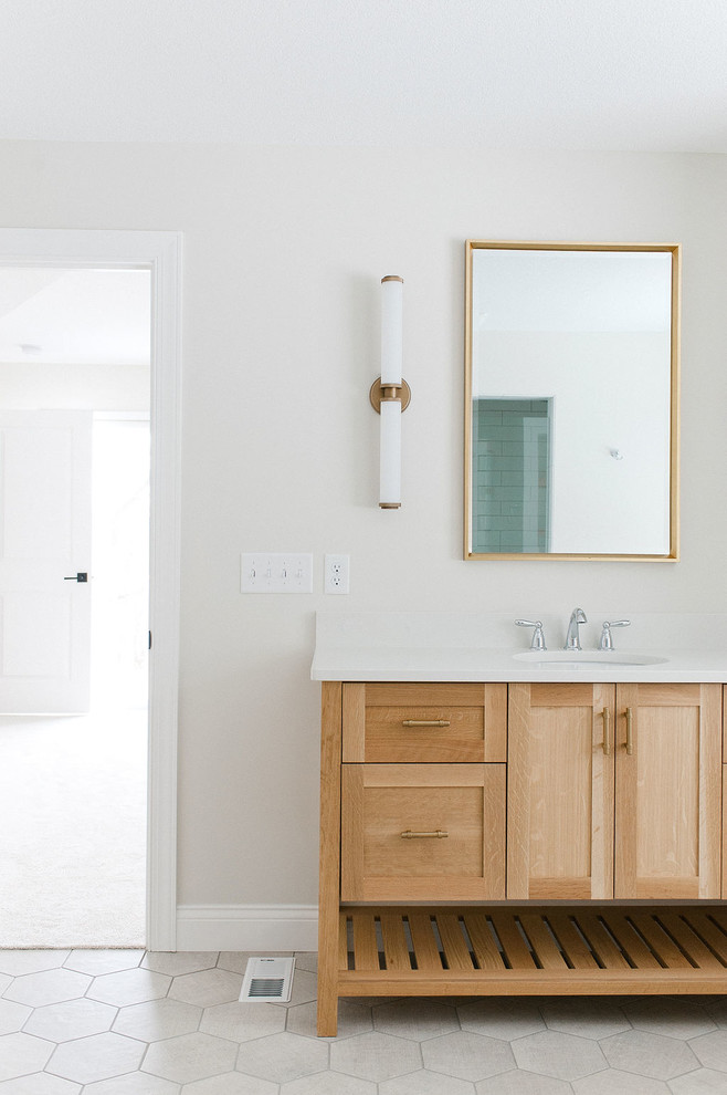 Large contemporary master bathroom in Minneapolis with shaker cabinets, light wood cabinets, a freestanding tub, an alcove shower, porcelain floors, an undermount sink, engineered quartz benchtops, grey floor, a hinged shower door, white benchtops and white walls.