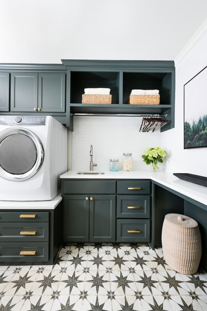 This is an example of a transitional laundry room in Houston.