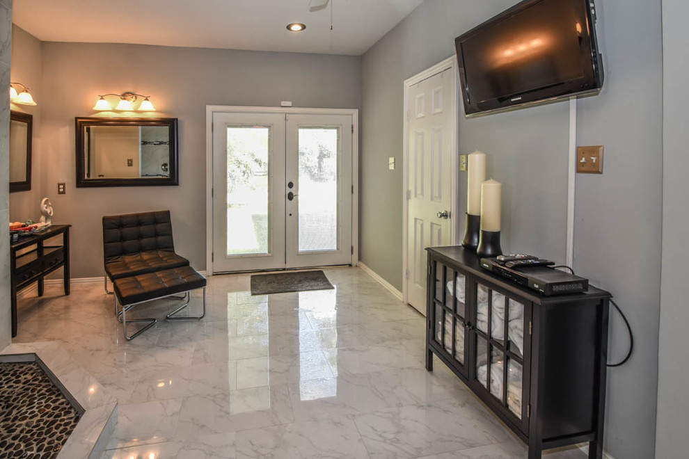 This is an example of an expansive contemporary master bathroom in Houston with glass-front cabinets, black cabinets, an open shower, white tile, stone tile, grey walls, marble floors, a vessel sink and marble benchtops.