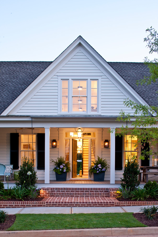 Inspiration for a country two-storey white exterior in Atlanta with wood siding.