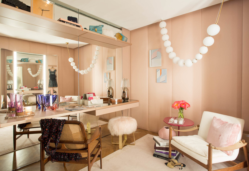 Design ideas for an eclectic women's dressing room in New York with medium hardwood floors.
