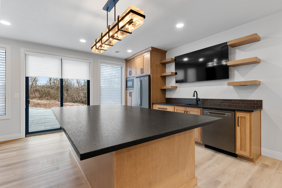 Example of a large transitional walk-out vinyl floor and white floor basement design with a bar and white walls
