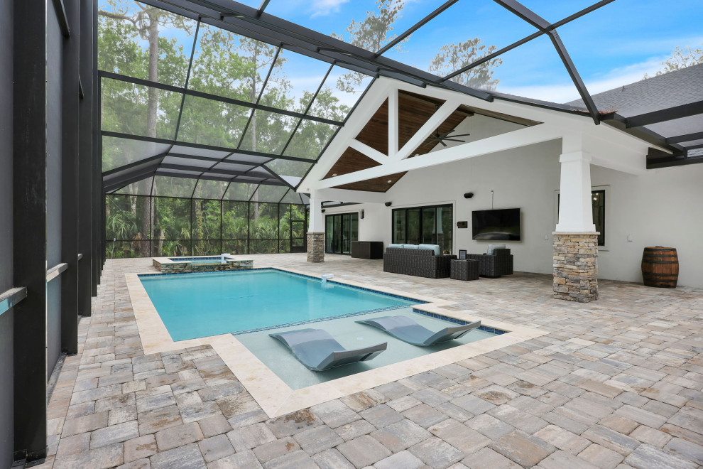 Design ideas for a mid-sized country backyard rectangular pool in Jacksonville with a hot tub and brick pavers.