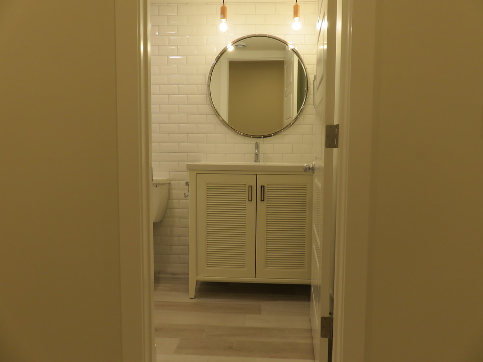 Example of a small transitional kids' white tile and subway tile ceramic tile and gray floor alcove bathtub design in Calgary with louvered cabinets, white cabinets, a two-piece toilet, white walls, an undermount sink and marble countertops