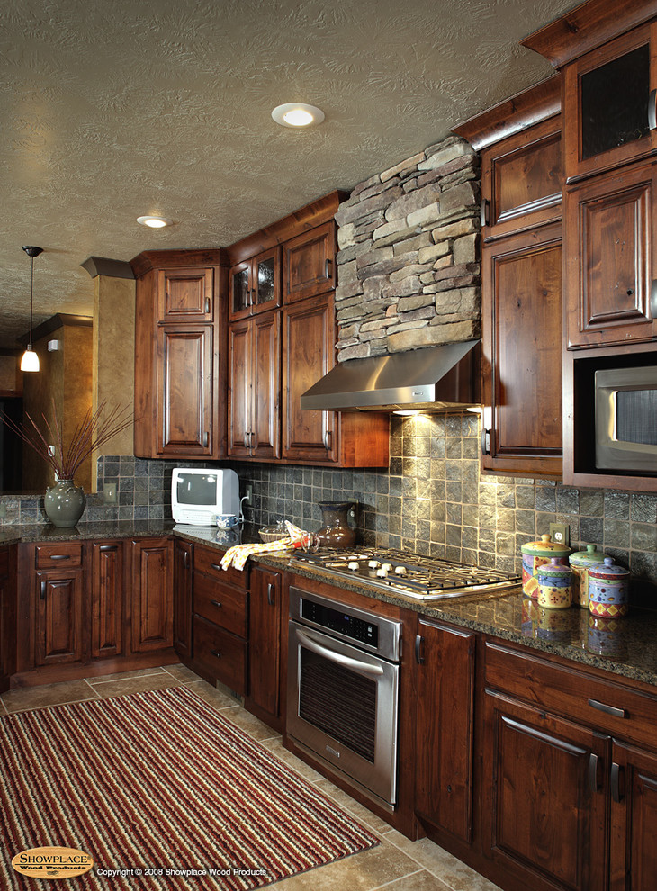 Kitchen - rustic porcelain tile kitchen idea with recessed-panel cabinets, dark wood cabinets, granite countertops, gray backsplash, stone tile backsplash and stainless steel appliances
