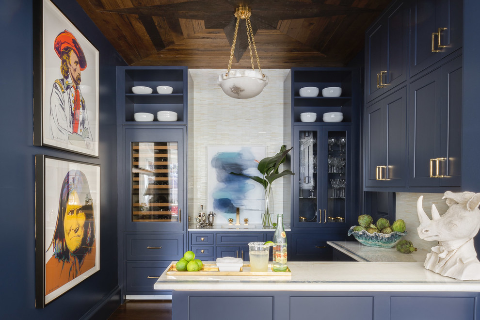 Inspiration for a transitional u-shaped wet bar in Dallas with an integrated sink, shaker cabinets, blue cabinets, white splashback, dark hardwood floors, brown floor and white benchtop.