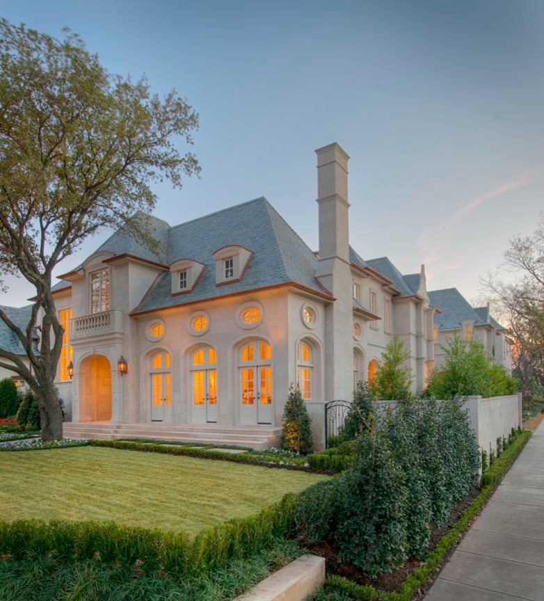 Inspiration for an expansive traditional three-storey beige house exterior in Dallas with stone veneer, a gable roof and a shingle roof.