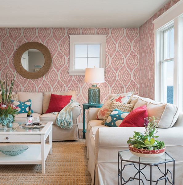This is an example of a tropical living room in Boston with pink walls.