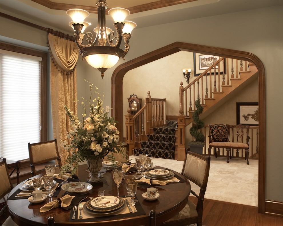 This is an example of a traditional dining room in Milwaukee with beige walls and dark hardwood floors.