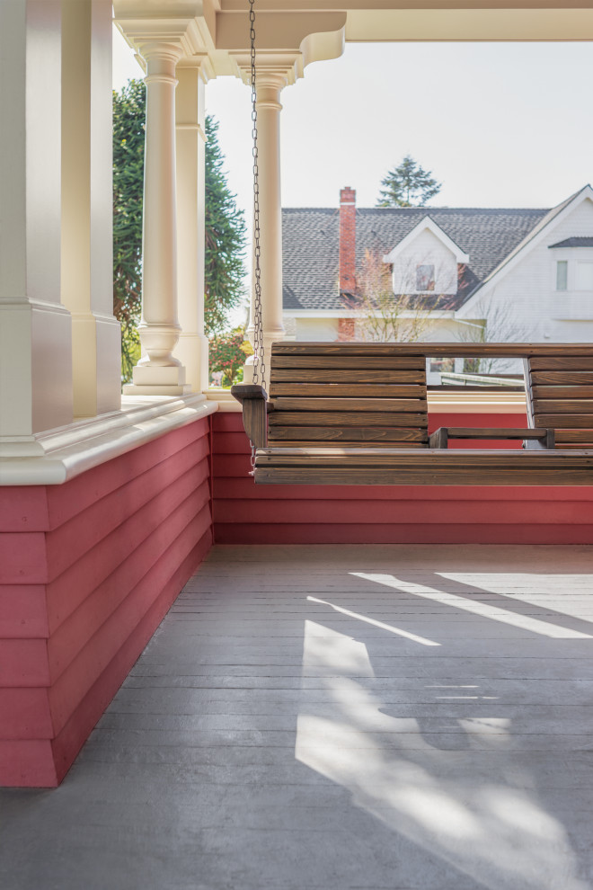 Mid-sized arts and crafts front yard verandah in Seattle with decking and a roof extension.