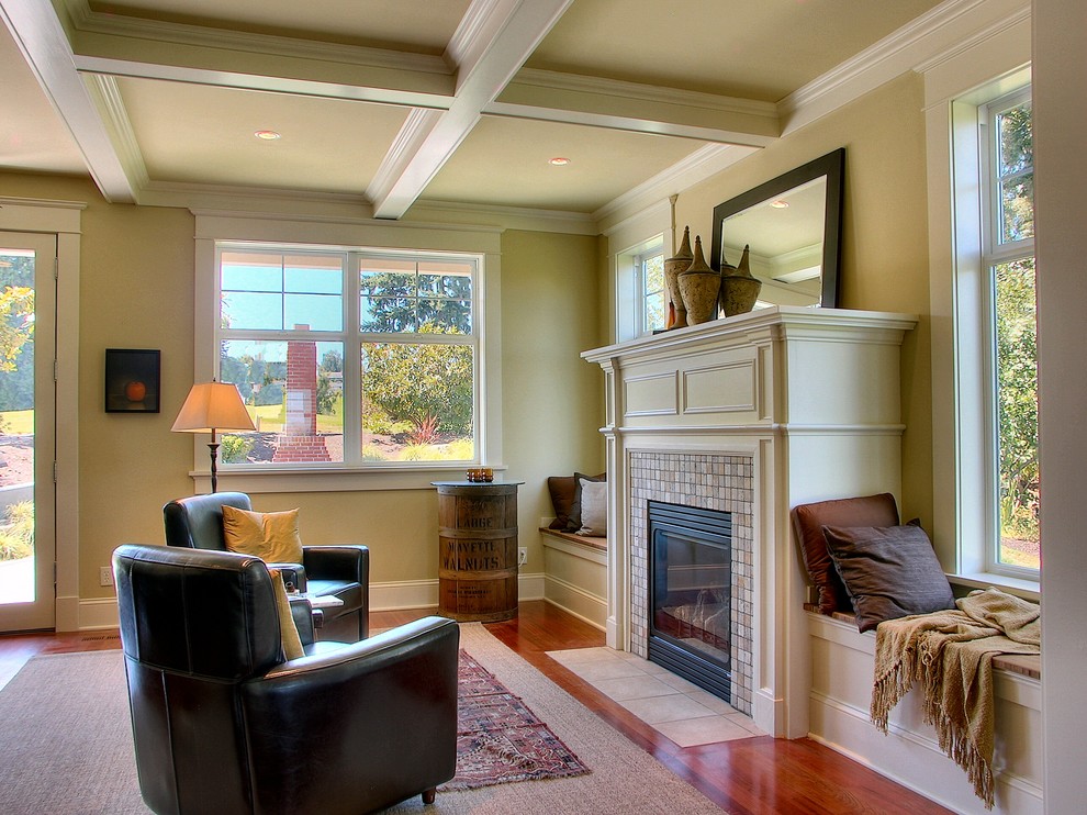This is an example of a traditional living room in Seattle with beige walls and a standard fireplace.