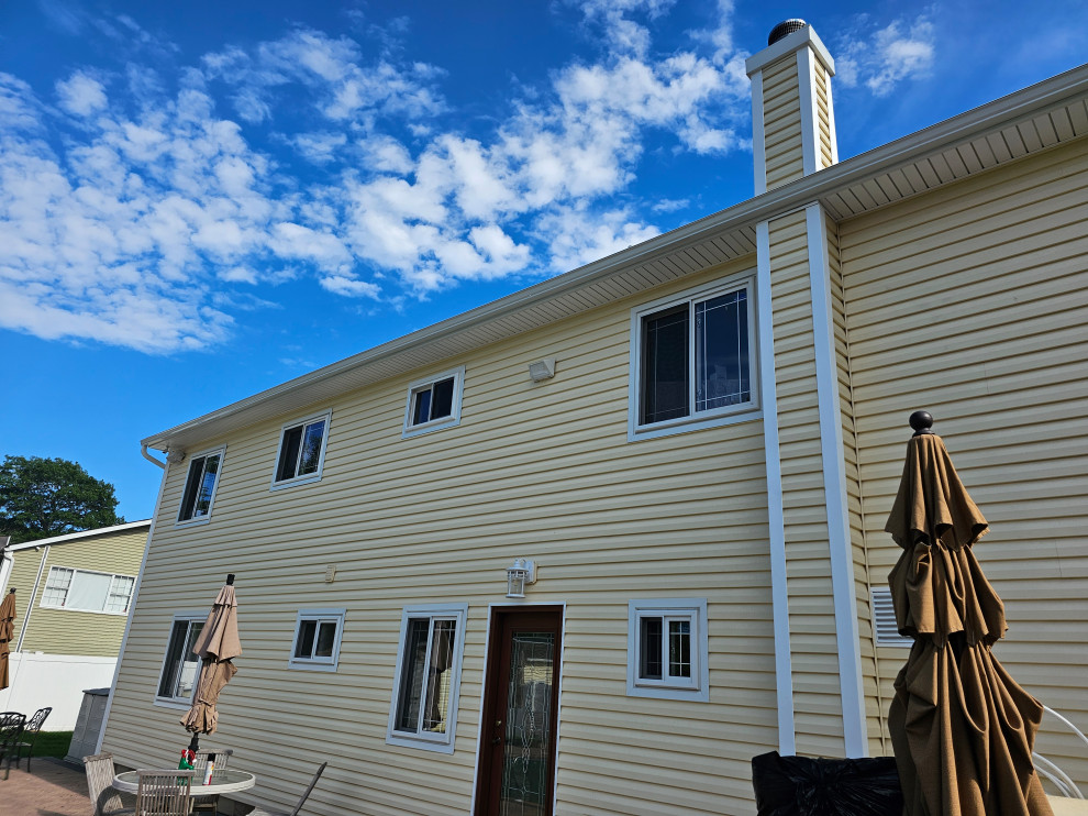 Rear facade, new siding and window trim