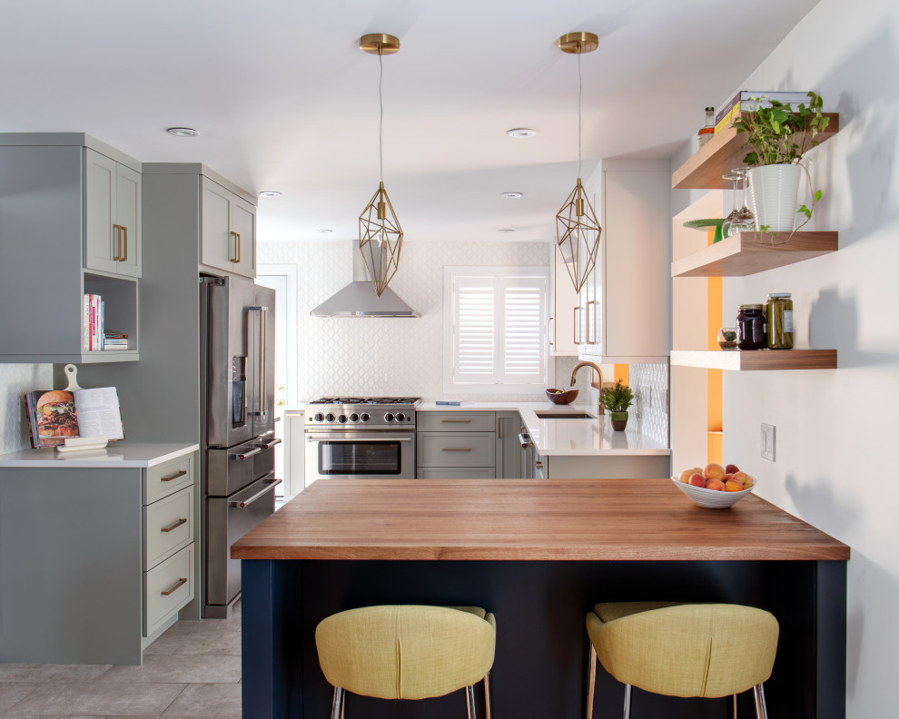 Inspiration for a mid-sized transitional l-shaped ceramic tile and gray floor eat-in kitchen remodel in Ottawa with a double-bowl sink, shaker cabinets, quartz countertops, white backsplash, stainless steel appliances, a peninsula, white countertops and gray cabinets