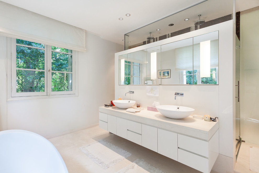 Inspiration for a large contemporary master bathroom in Paris with a vessel sink, flat-panel cabinets, white cabinets and white walls.