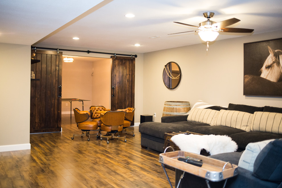 Mid-sized mountain style underground medium tone wood floor basement photo in St Louis with beige walls and no fireplace